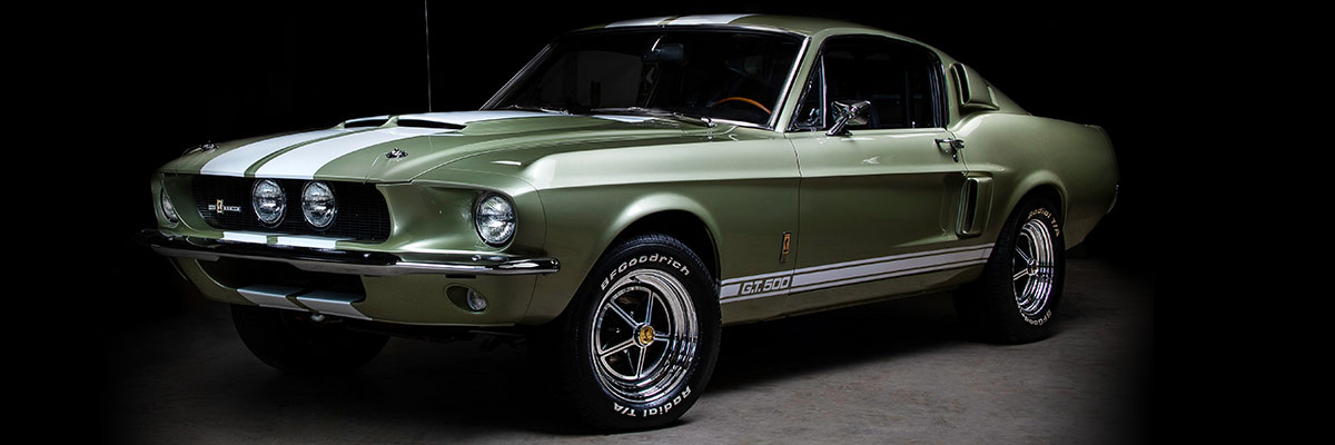 Green muscle car on black background